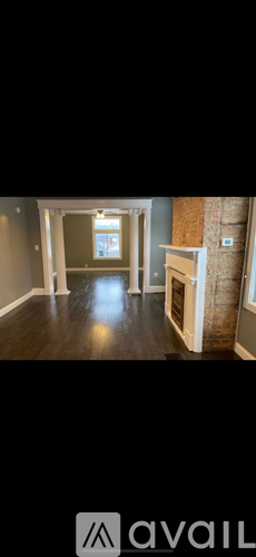 A room with a fireplace and a large window.