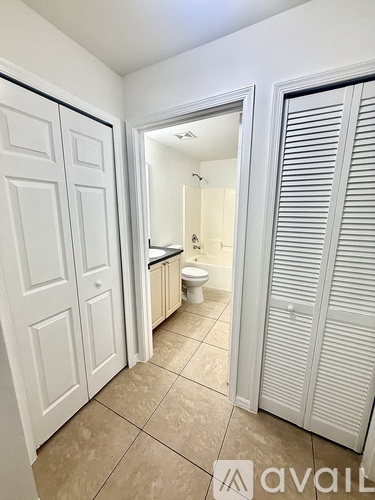 A bathroom with a toilet, sink, and a white door.