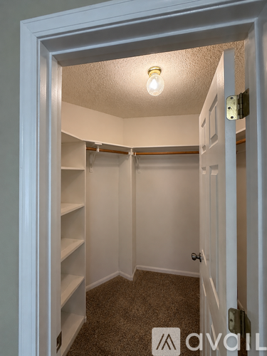 A small, empty room with a light bulb on the ceiling.