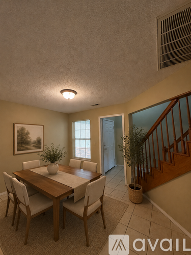 A dining room with a wooden table and chairs.