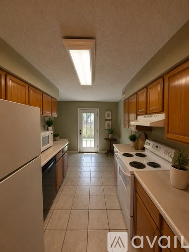A kitchen with wooden cabinets and a white refrigerator.