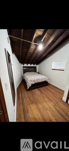 A bedroom with a bed and a window.