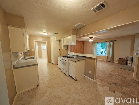 A kitchen with beige cabinets and appliances is available for rent.