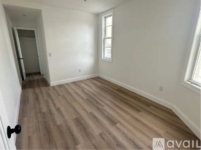 A room with wooden flooring and a window.