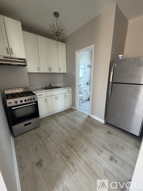 A kitchen with a stove, oven, and refrigerator.