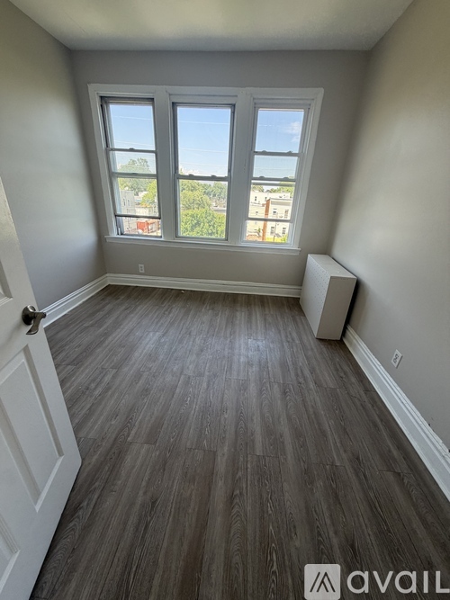 A room with a window and a door.