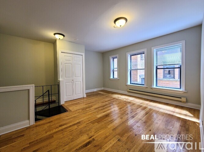 A room with wooden floors and a white door.
