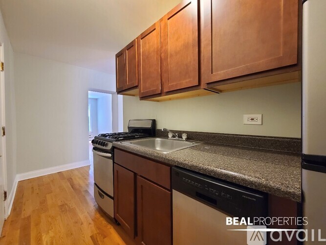 A kitchen with wooden cabinets and a granite countertop.