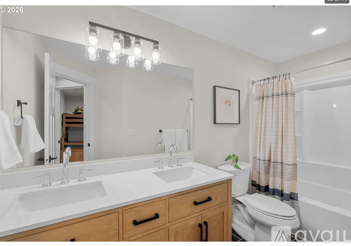 A bathroom with a white countertop and a white sink.