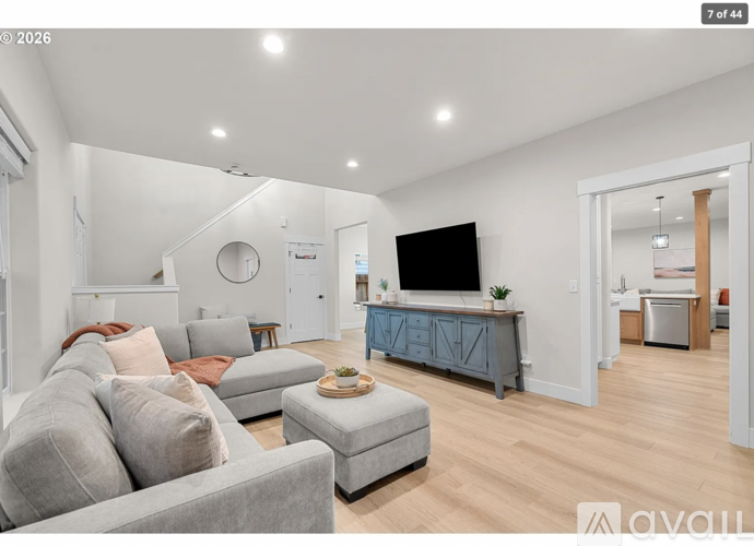 A living room with a grey couch and a television.