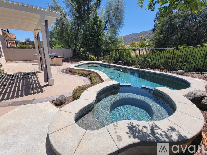 A pool with a hot tub in the middle of it.