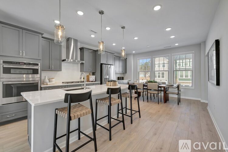 A modern kitchen with a dining area and a large island.