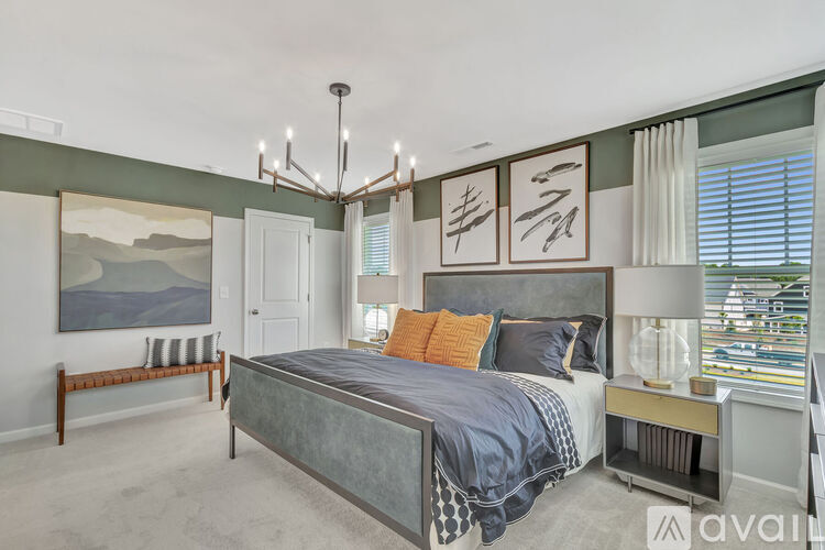 A bedroom with a large bed and a chandelier.