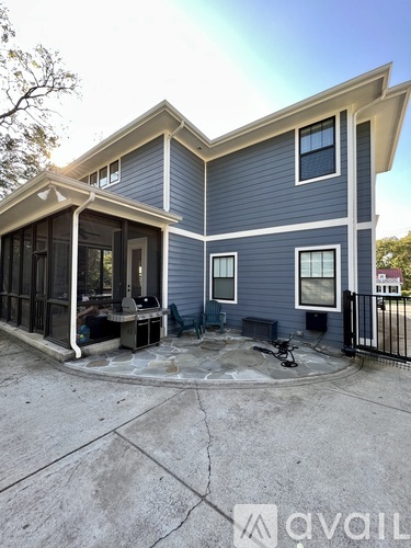 A house with a grey and blue exterior is shown.