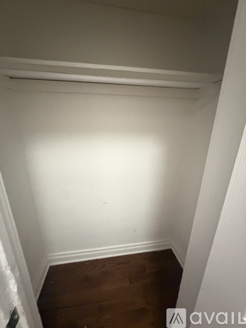 A room with a wooden floor and white walls.