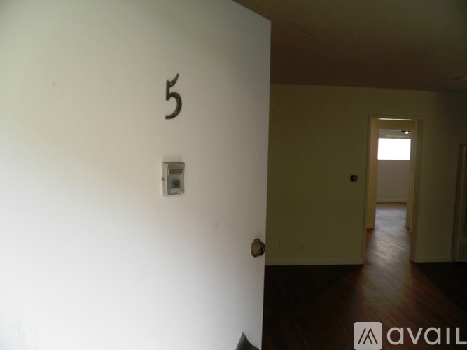 A room with a door numbered 5 and a light switch.