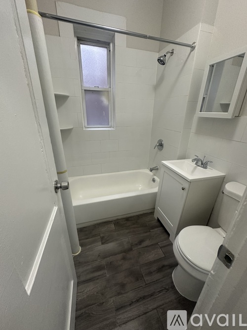A small bathroom with a toilet, sink, and bathtub.