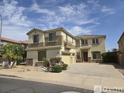 A house with a beige exterior and a brown roof.