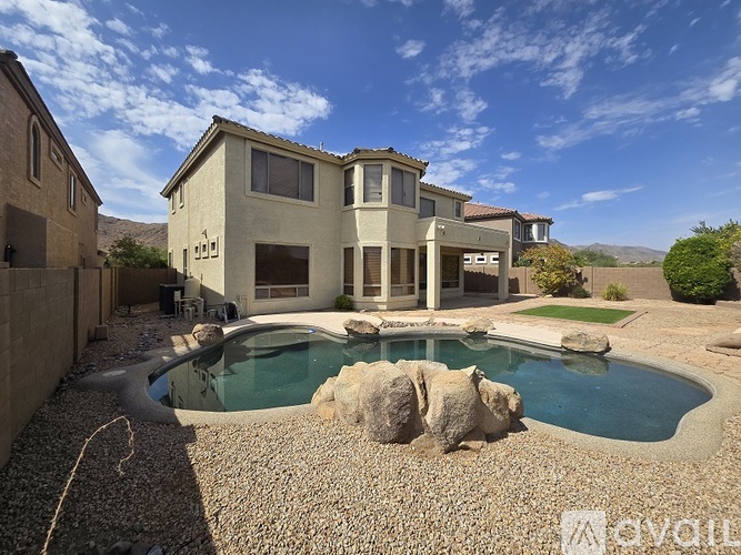 A large house with a pool in the backyard.