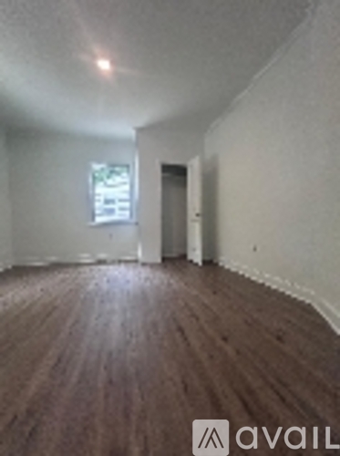 A room with wooden floors and a window.