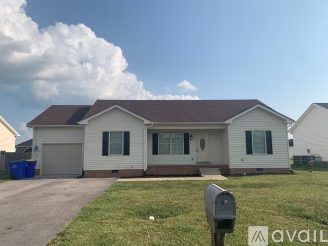 A house with a brown roof and a white garage door.