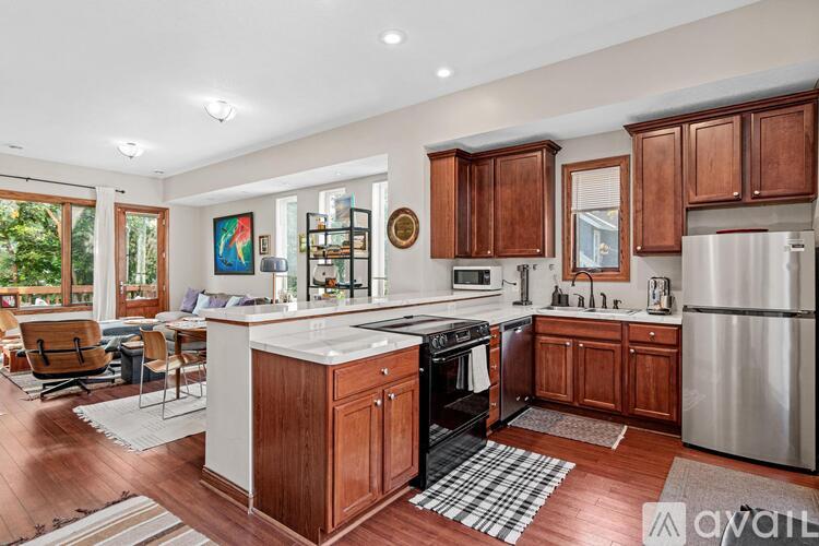 A kitchen with wooden cabinets and a white island.