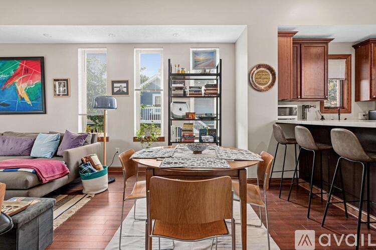 A living room with a dining table and chairs.
