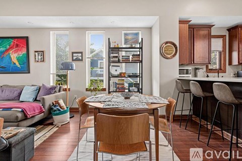 A living room with a dining table and chairs.