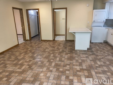 A kitchen area with a white counter and a refrigerator.