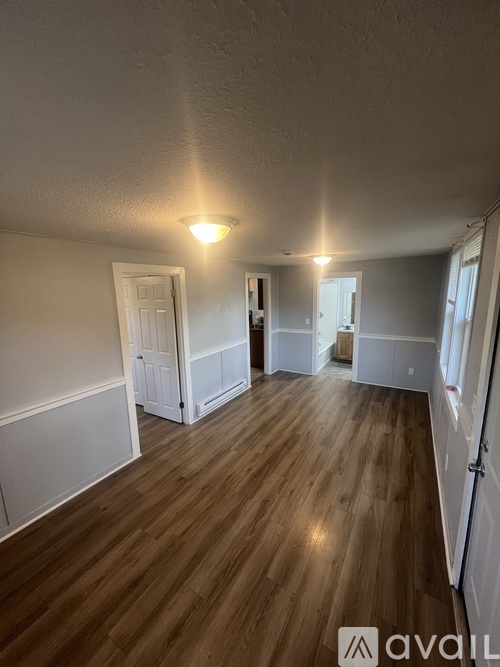 A room with wooden floors and white walls.