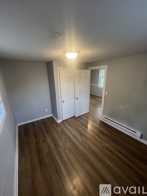 A room with wooden floors and white walls.
