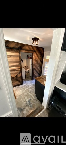 A room with wooden walls and a white door.