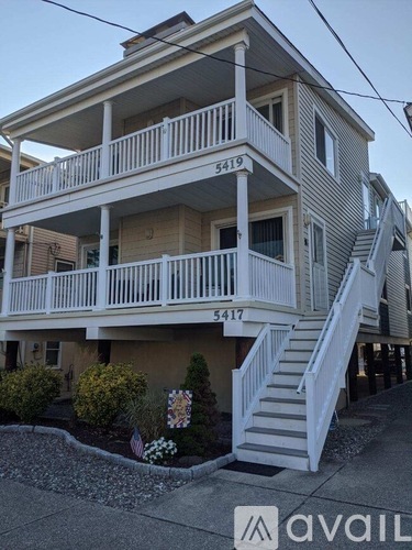 A two-story house with the number 54179 on the front.