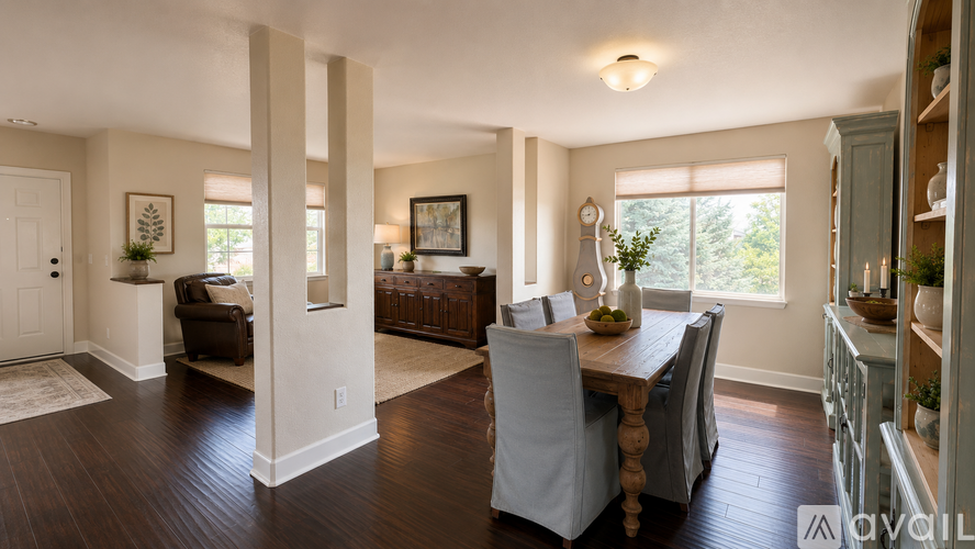 A dining room with a wooden table and chairs.