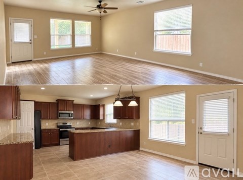 A living room with a ceiling fan and a kitchen with brown cabinets.