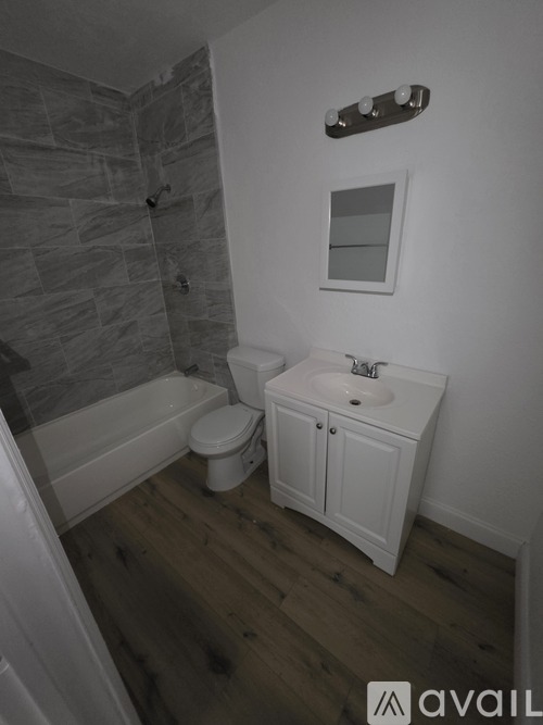 A bathroom with a toilet, sink and tub.