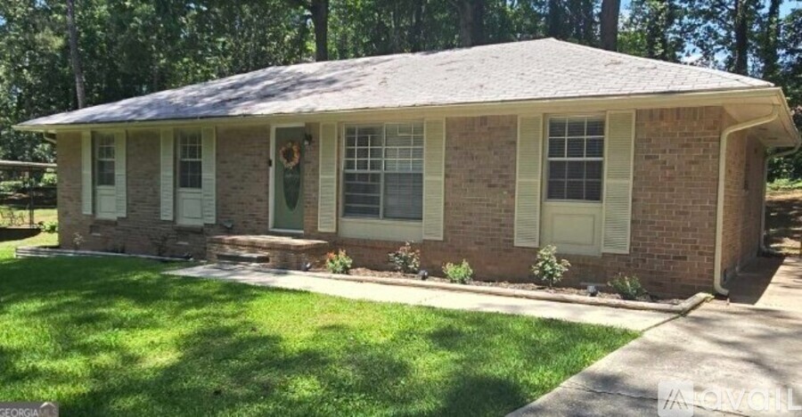 A small house with a green lawn in front.