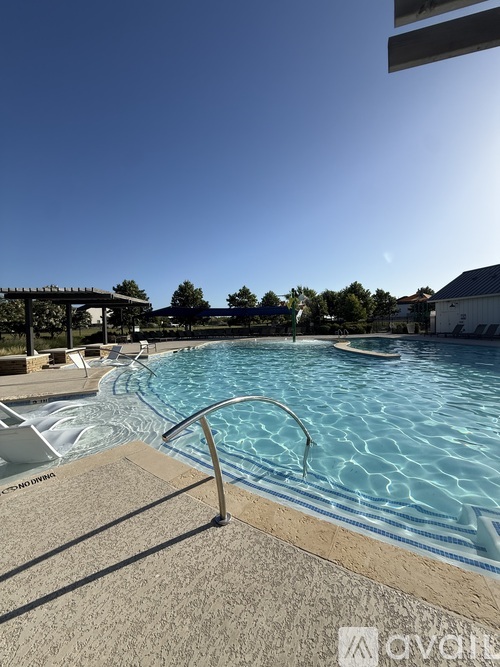 A swimming pool with a metal ladder in the middle of it.