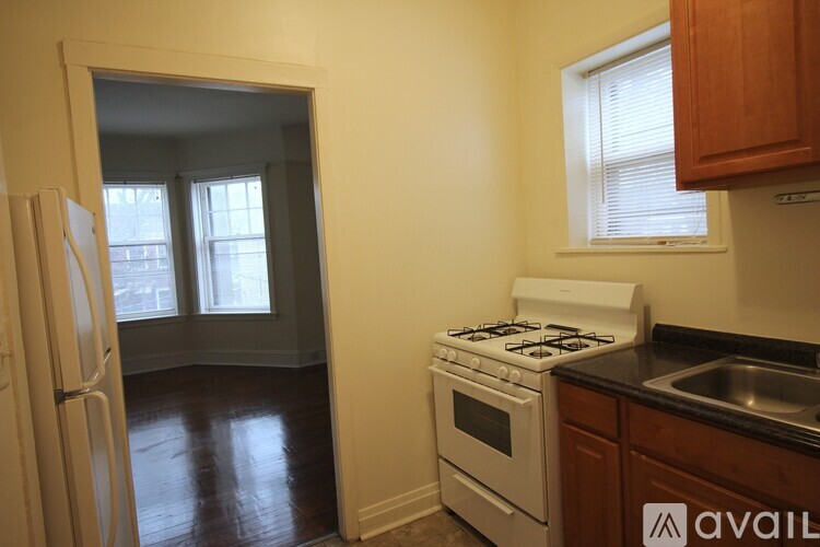 A kitchen with a white stove and a white refrigerator.