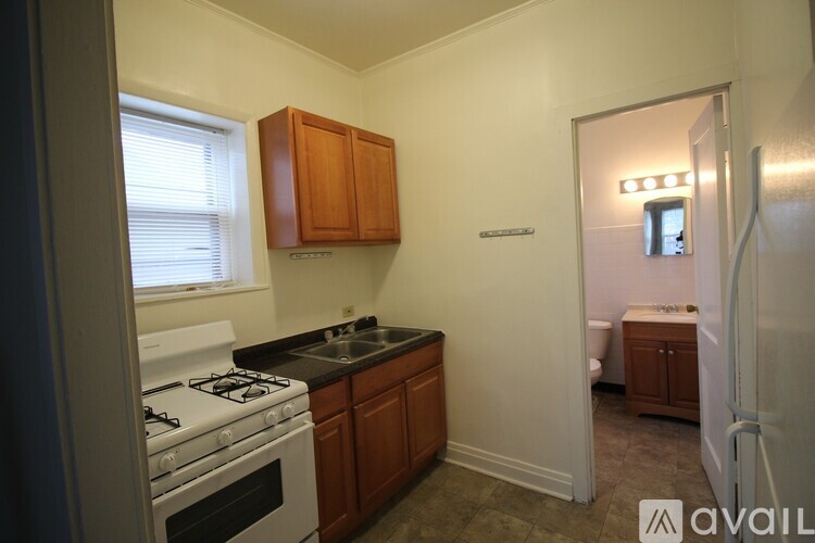 A kitchen with a stove top oven and a sink.
