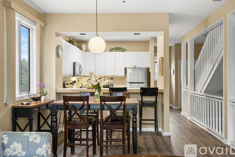 A kitchen with a table and chairs in front of it.