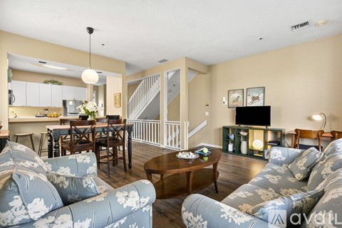 A living room with a grey couch and a wooden coffee table.
