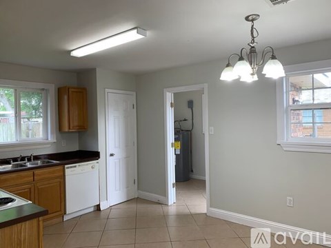 A kitchen with a dishwasher and a refrigerator.