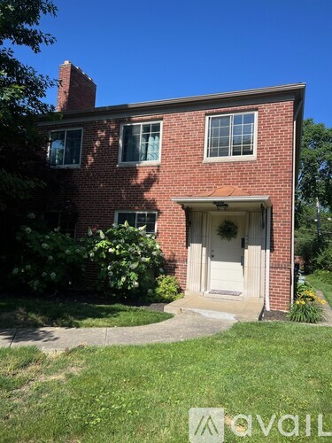 A brick house with a white door and a small porch.