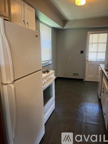 A kitchen with a white fridge and stove.