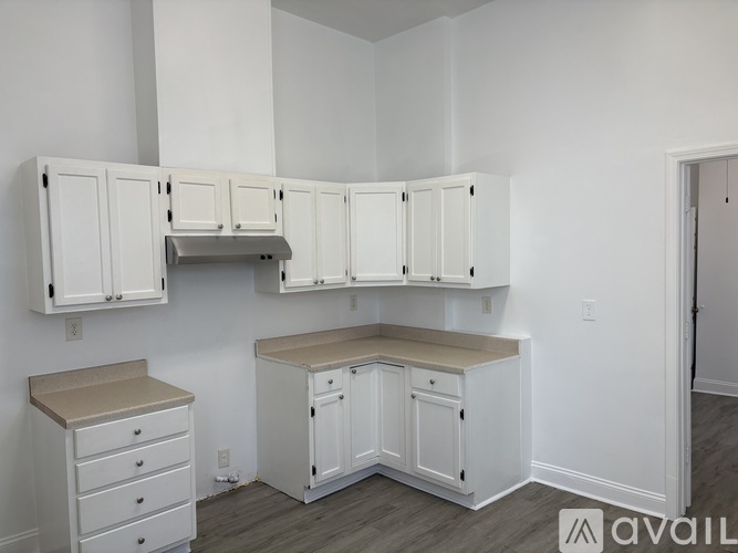 A kitchen with white cabinets and a countertop.