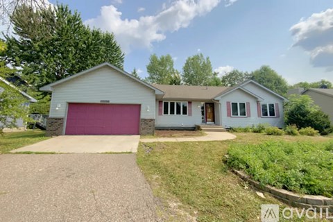 A house with a red garage door is for sale.