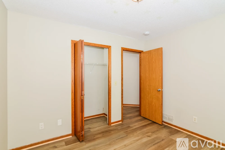 A room with two doors and wooden floors.