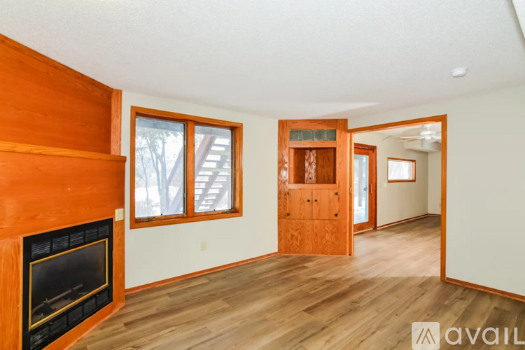 A room with a fireplace and wooden floors.