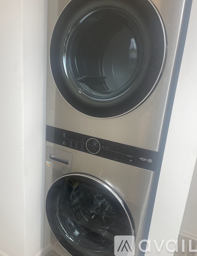 A front-loading washing machine with the door open.